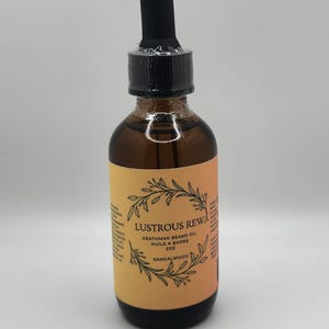 May include: A brown glass bottle of Lustrous Rewa Gentleman Beard Oil with a black dropper. The label is orange and yellow with the text "Sandalwood" and a botanical illustration. The bottle contains 2 oz of beard oil.