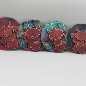 Ornamento de tartan gravado em vaca das montanhas