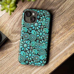 May include: A smartphone case featuring a repeating pattern of turquoise-colored stones arranged in floral and circular shapes with dark metallic accents. The design covers the entire back of the case, including the area around the camera lens.