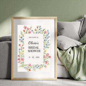 May include: A printable bridal shower invitation with a floral border. The text reads "Welcome to Olivia's Bridal Shower 13. 05. 2025".