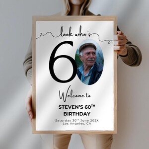 May include: A white poster with black text and a photo of a man. The poster says "Look who's 60! Welcome to Steven's 60th Birthday. Saturday 30th June 202X Los Angeles, CA"
