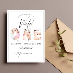 May include: A white invitation card with the text "Olivia Stone is a Wild One" and three baby photos. The invitation includes the date, time, and RSVP information. A brown envelope with greenery is in the background.