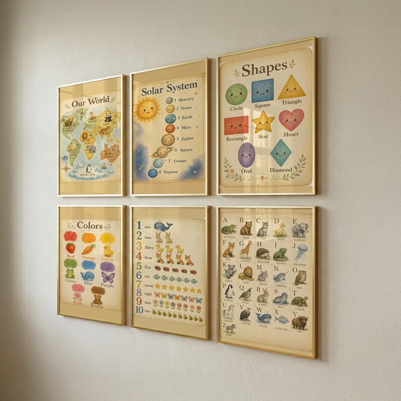 May include: A set of six educational wall posters in gold frames, featuring illustrations of the world map, solar system, shapes, colors, numbers one through ten, and an alphabet chart with animals, all displayed in a grid on a plain wall.