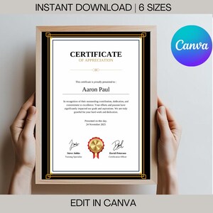 May include: A black and gold certificate of appreciation with a gold seal. The certificate is framed and reads "Certificate of Appreciation" and "Aaron Paul".
