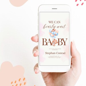 May include: A smartphone displaying a baby shower invitation with a teddy bear holding balloons. The invitation reads "We can bearly wait Baby" and includes the name "Stephan Conrad".