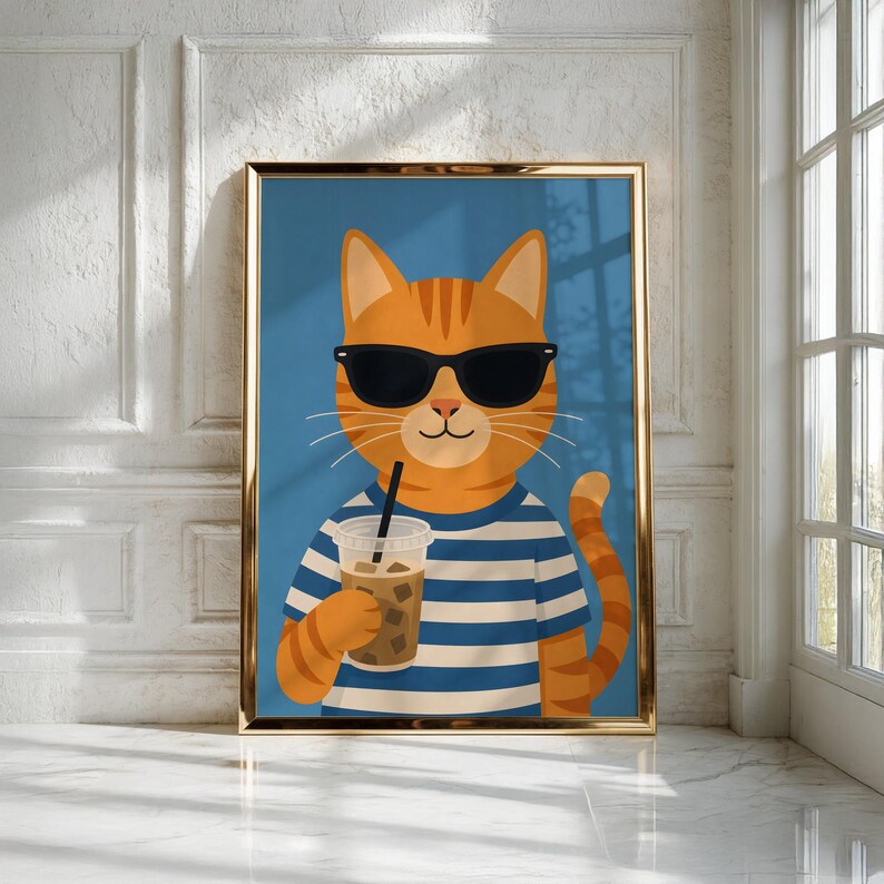 May include: A framed wall art print featuring an orange tabby cat wearing black sunglasses and a blue and white striped shirt. The cat is holding a clear plastic cup filled with an iced beverage and a black straw against a solid blue background.