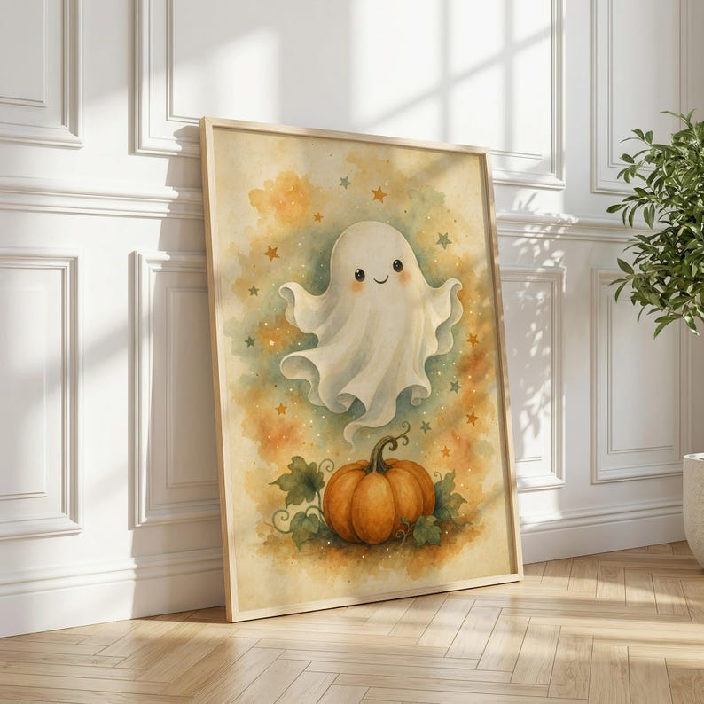 May include: A framed vertical wall art print featuring a watercolor illustration of a smiling white ghost floating above an orange pumpkin. The background is a soft blend of yellow and orange hues with small scattered stars throughout the composition.