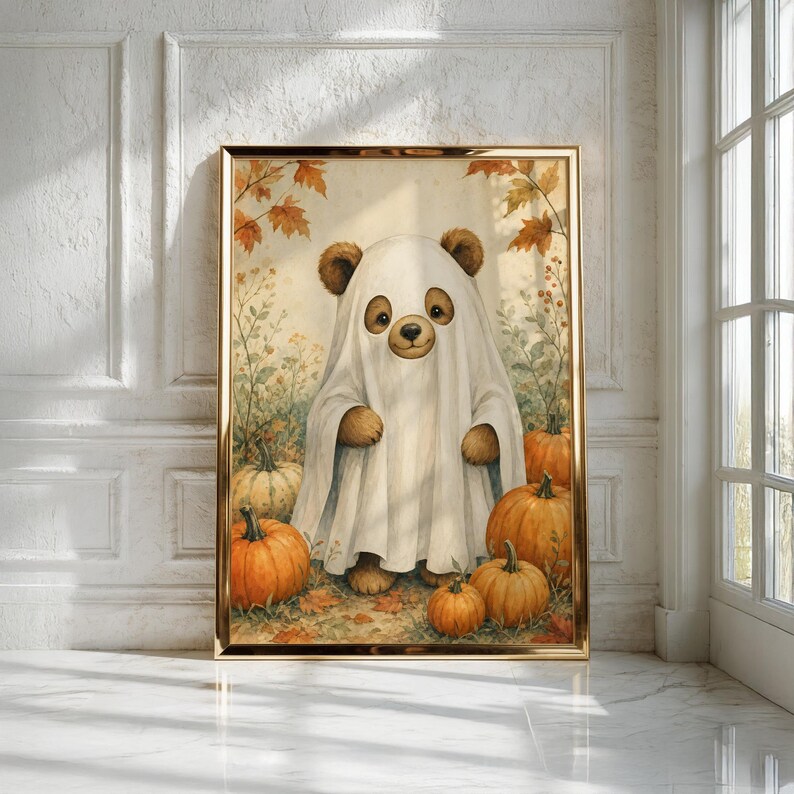 May include: A framed wall art print featuring a brown bear wearing a white ghost costume made from a sheet. The bear stands in a field of orange pumpkins and autumn leaves. The scene is rendered in a soft, painterly style with warm fall colors.