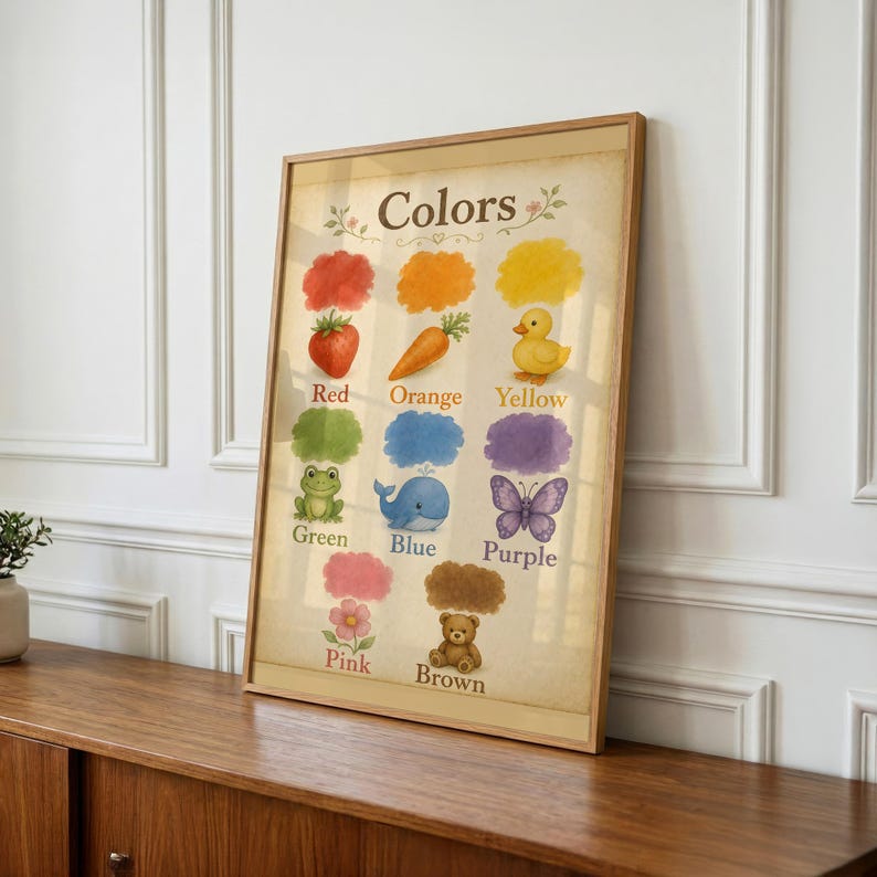 May include: A framed educational wall art print titled Colors, featuring illustrations of a red strawberry, orange carrot, yellow duck, green frog, blue whale, purple butterfly, pink flower, and brown teddy bear, each with its corresponding colour name.