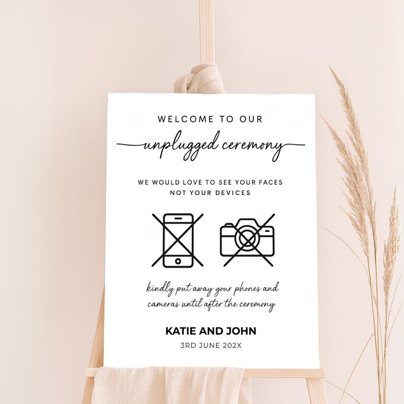 Modern unplugged wedding sign with crossed-out phone and camera icons, custom couple name and date. Clean design with script and sans-serif fonts, ideal for contemporary weddings.