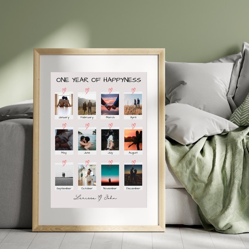 May include: A framed print with a collage of 12 photos of a couple, each photo representing a different month of the year. The title of the print is "One Year of Happiness" and the couple's names are "Lerissa & John" at the bottom.