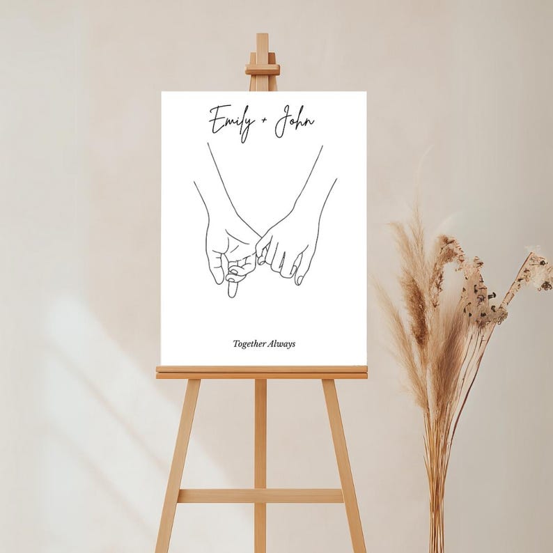 以下が含まれることがあります： 2つの手が絡み合った白黒の線画で、画像の下に「Emily + John」と「Together Always」のテキストがあります。
