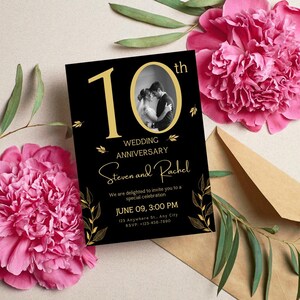 May include: A black wedding anniversary invitation with gold text and accents. The invitation includes a photo of a couple, the words "10th Wedding Anniversary", and the names "Steven and Rachel". Pink flowers and a brown envelope are in the background.