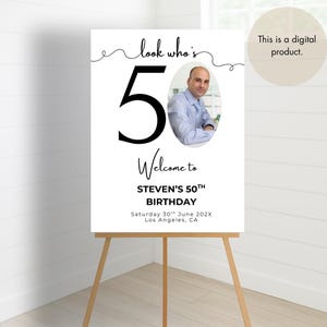 May include: A white welcome sign with black text and a photo of a person. The sign says "Look who's 50! Welcome to Steven's 50th Birthday. Saturday 30th June 202X. Los Angeles, CA."