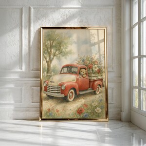 May include: A framed wall art print depicting a vintage red and cream pickup truck driving through a field of wildflowers. A teddy bear sits in the driver seat, and the truck bed is filled with a large bouquet of colorful flowers and greenery.