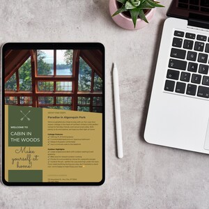 May include: A digital tablet displaying a brochure for a cabin rental in Algonquin Park. The brochure features a photo of a large window with a view of a lake and trees. The text on the brochure reads "Welcome to Cabin in the Woods" and "Paradise in Algonquin Park".