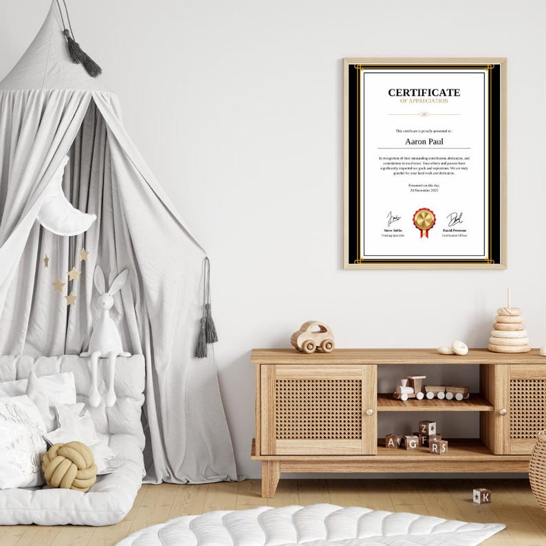 May include: A framed certificate of appreciation with a gold seal and black and gold border. The certificate is presented to Aaron Paul. The certificate is displayed on a wooden shelf with a toy car and a wooden toy tower.