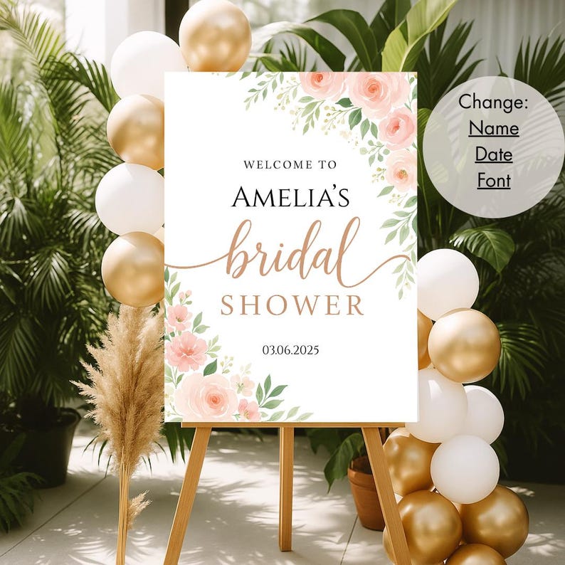 Op de afbeelding: Een wit bord met een bloemenontwerp en de tekst "Welkom bij Amelia's bruidsdouche 03.06.2025".