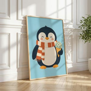 May include: A framed wall art print featuring a cartoon penguin with a black and white body, wearing an orange and white striped scarf, and holding a light green mint chocolate chip ice cream cone against a solid light blue background.