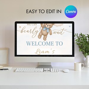 May include: A digital printable sign with a blue and white background featuring a teddy bear holding a blue balloon. The text reads "We can barely wait, Welcome to Liam's".