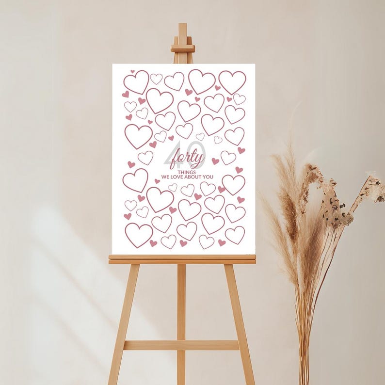 May include: A white sign on a wooden easel, featuring a design of hearts in varying sizes. The text "forty" is displayed in a cursive font, with the words "THINGS WE LOVE ABOUT YOU" below. The hearts are outlined in a soft pink.