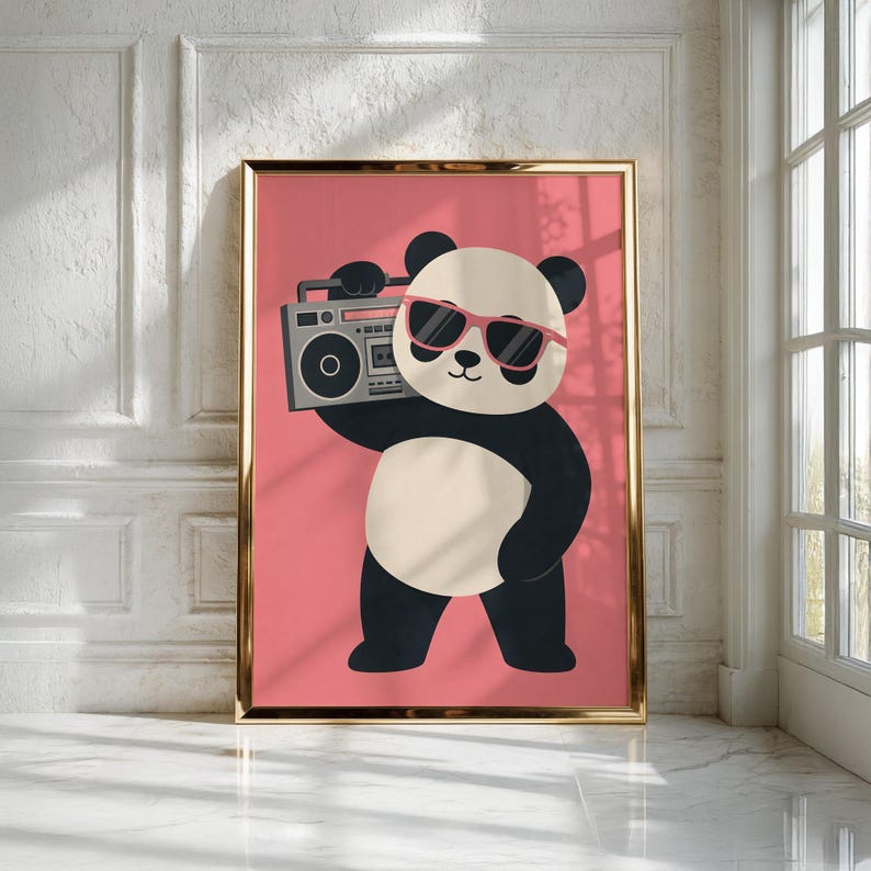 May include: A framed wall art print featuring a cartoon panda with black and white fur, wearing pink sunglasses, and holding a grey boombox on its shoulder. The panda is centered against a solid pink background within a thin gold frame.