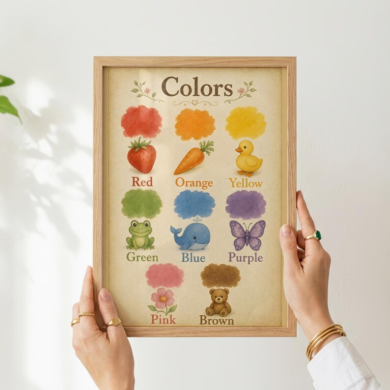 May include: A framed educational wall art print titled Colors, featuring watercolour illustrations of a red strawberry, orange carrot, yellow duck, green frog, blue whale, purple butterfly, pink flower, and brown teddy bear on a beige background.