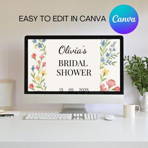 May include: A computer screen displaying a floral bridal shower invitation for Olivia's bridal shower on May 13, 2025. The invitation has a white background with watercolor flowers in shades of pink, blue, and yellow.