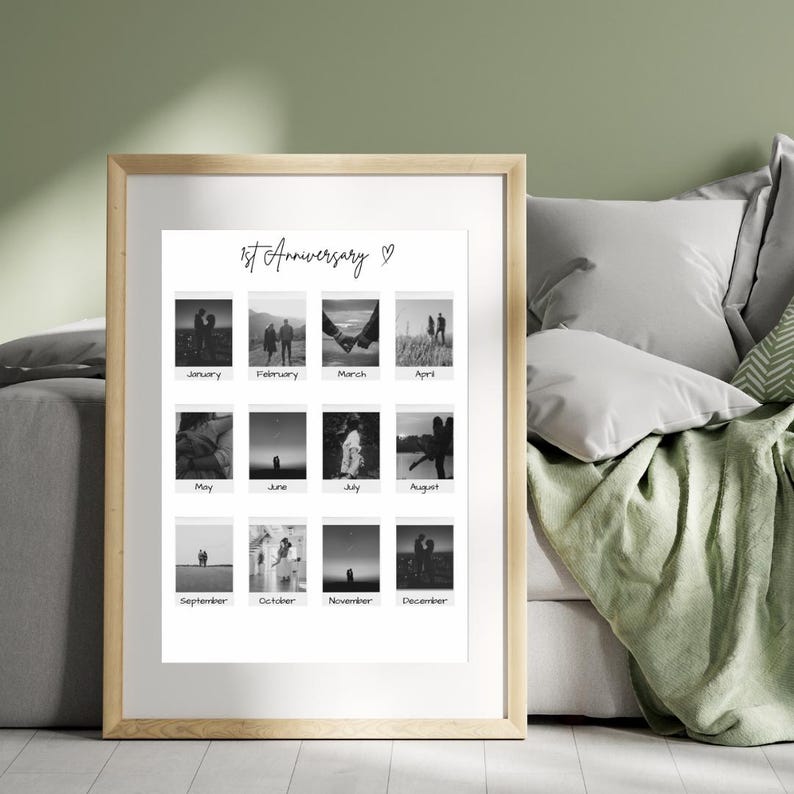 May include: A black and white photo collage of a couple's first year together. The collage is in a white frame with a wooden border. The photos are arranged in a grid of four rows and three columns. Each photo is labeled with a month of the year. The title of the collage is "1st Anniversary" with a heart symbol.