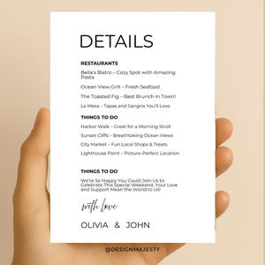 May include: A white card held in a hand, featuring the word "DETAILS" at the top. Below, lists of restaurants and things to do are printed in black. The card includes the names Olivia & John and the phrase "with love."