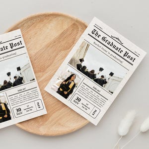 May include: A graduation announcement in the style of a newspaper with a black and white design. The headline reads "The Graduate Post" and the subheading reads "Rachel Stone is graduating!" The announcement includes two photos of the graduate in cap and gown. The announcement also includes the date and time of the graduation ceremony.