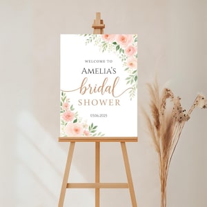 Bridal shower welcome sign with blush pink roses, soft greenery, and elegant fonts. Features bride’s name and date. Perfect for spring or romantic bridal themes, editable in Canva.