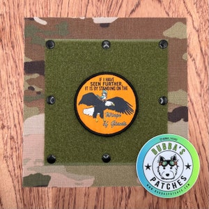 May include: A green patch with a velcro backing featuring a cartoon eagle with a bird on its back. The patch has the text "If I have seen further, it is by standing on the Wings of Giants".