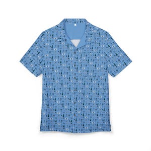 May include: A light blue short-sleeved button-down shirt with a white collar and a pattern of small camping-themed icons.