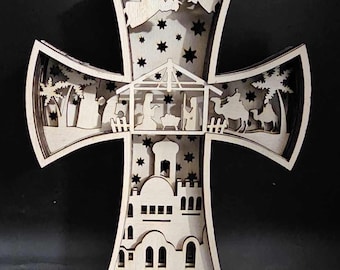 May include: A wooden cross with a layered design depicting the nativity scene. The cross is decorated with stars and the words "Merry Christmas".