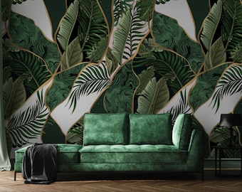 May include: A green velvet sofa with a black throw blanket in front of a wall with a tropical leaf pattern. The wallpaper features gold accents and a marble-like design.