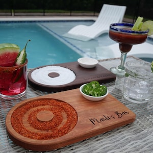 May include: Three wooden serving trays with salt, chili powder, and a small bowl for jalapenos. The trays are engraved with the text "Susan & Yasin" and "Marli's Bar".