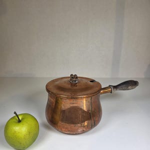 May include: A white-painted wooden 'Welcome' sign with a distressed finish, featuring a floral design in pink and green. The sign is crafted by hand and suitable for indoor or outdoor display. The text is in a playful font.