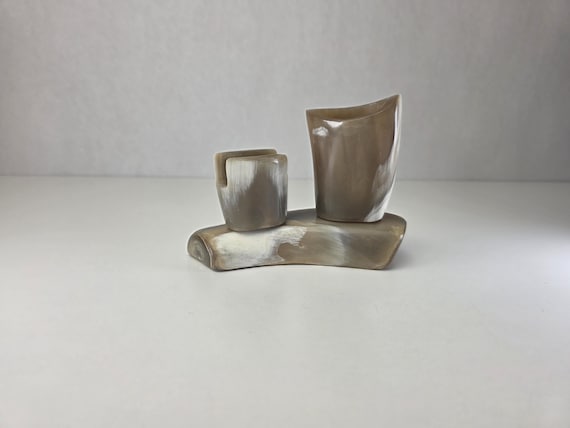 A genuine handmade natural horn sculpture that brings raw organic texture and MCM silhouette to any desk or shelf — the kind of thing you find in a well-traveled person's study.