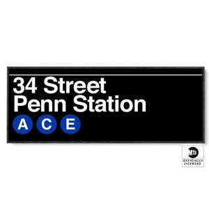 May include: Black rectangular sign with white text reading "34 Street Penn Station." Below the text are three blue circles with the letters "A", "C", and "E". The sign has a black border and the MTA logo.