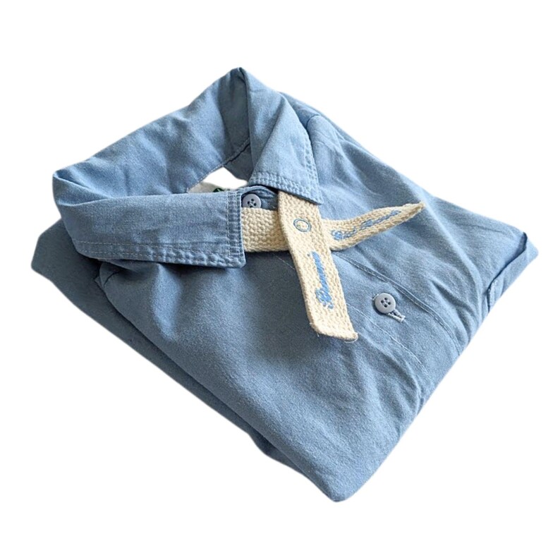 May include: A pale blue button-down shirt with a cream-coloured belt. The shirt is folded and has a classic collar and buttoned cuffs. The belt is secured with a button and has light blue text.