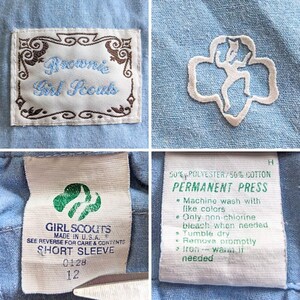 May include: Close-up of a light blue Girl Scout uniform shirt. The shirt features a Brownie Girl Scouts patch, a Girl Scout trefoil emblem, and a label indicating it's a short sleeve size 12, made in the U.S.A. The care instructions are also visible.