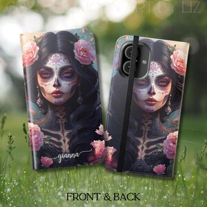 May include: A phone case featuring a Day of the Dead design. The case displays a woman with sugar skull makeup, adorned with pink roses and long black hair. The name "gianna" is written on the front. The case is shown open and closed, with the words "FRONT & BACK" at the bottom.