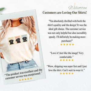 May include: A cream-coloured t-shirt with three postage stamp-style graphics of a black Labrador Retriever. The shirt also has the text "Forever Love" above each dog image. The shirt is being modelled by a person wearing blue jeans.