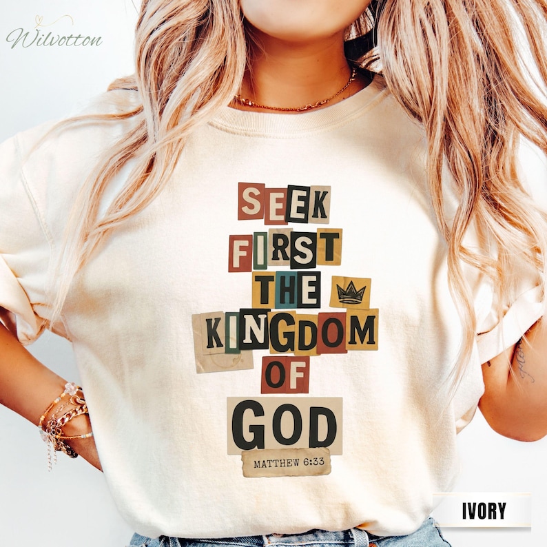 May include: Ivory sweatshirt featuring the text "SEEK FIRST THE KINGDOM OF GOD" in a collage design. Includes a small crown graphic and the Bible verse Matthew 6:33.