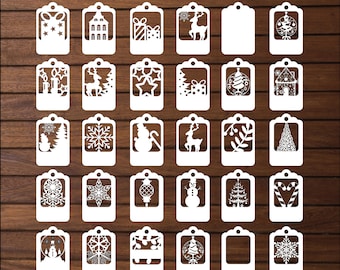 Op de afbeelding: Set van 25 witte kerstcadeau-etiketten met verschillende feestelijke ontwerpen, waaronder sneeuwvlokken, rendieren, kerstboom en ornamenten. De etiketten zijn in een decoratieve stijl uitgesneden, perfect om een feestelijke touch aan cadeaus te geven.