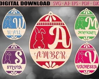 May include: Five wooden Easter egg ornaments with bunny silhouettes and personalized names. The eggs are painted in various colors, including blue, green, red, purple, and pink. The names are "Wal", "Amber", "Michael", "Silvia", and "Vanessa".