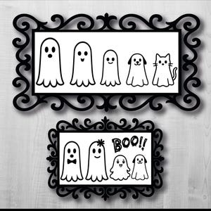 May include: Two black framed Halloween art pieces. The top frame has six white ghost illustrations, including a cat and dog. The bottom frame has four ghost illustrations and the word "BOO!!".