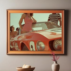 May include: Framed print featuring a vintage red sports car with a woman in a red and white checkered swimsuit leaning against it. Other people are visible. The image has a retro aesthetic.