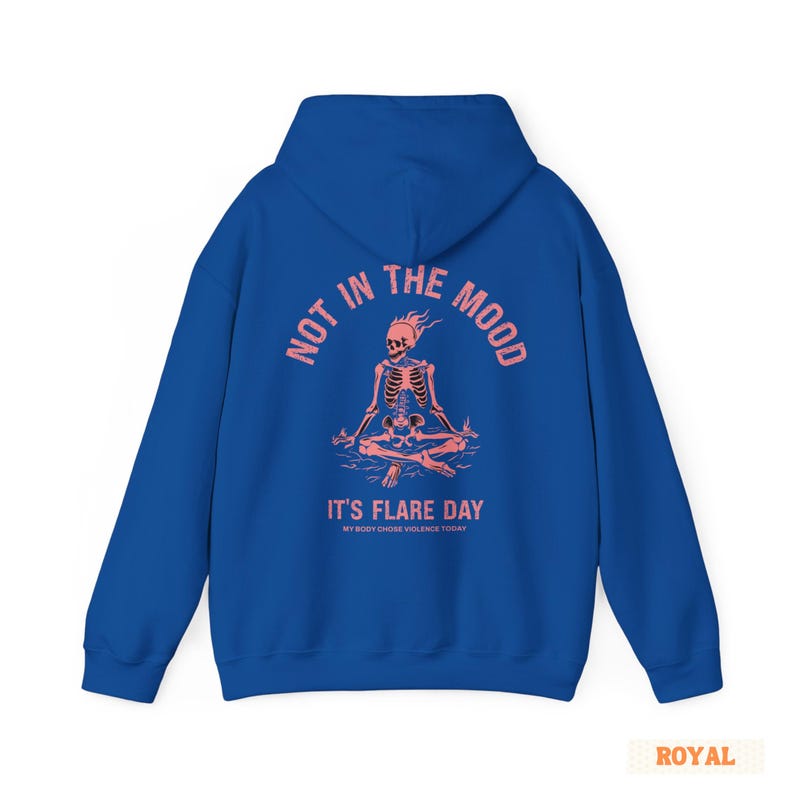 unisex chronic illness hoodie in color royal blue. Graphic of a pink skeleton in flames with a phrase not in the mood its flare day in grunge font in pink.